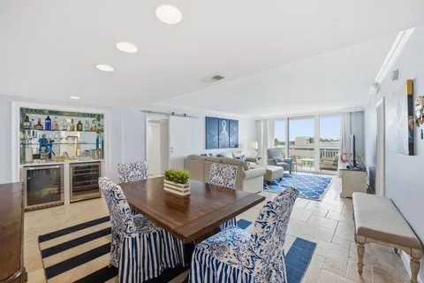 a living room with furniture large window and a flat screen tv