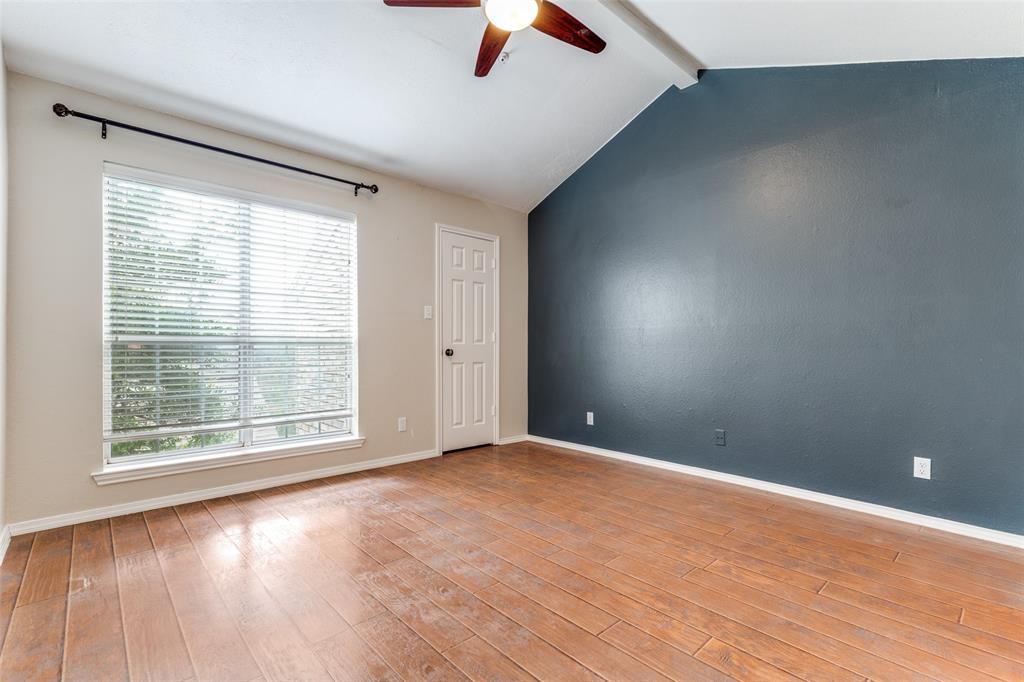 5565 Preston Oaks Road, Unit 237 Dallas, TX 75254 - Photo 6 of 14 an empty room with wooden floor and windows