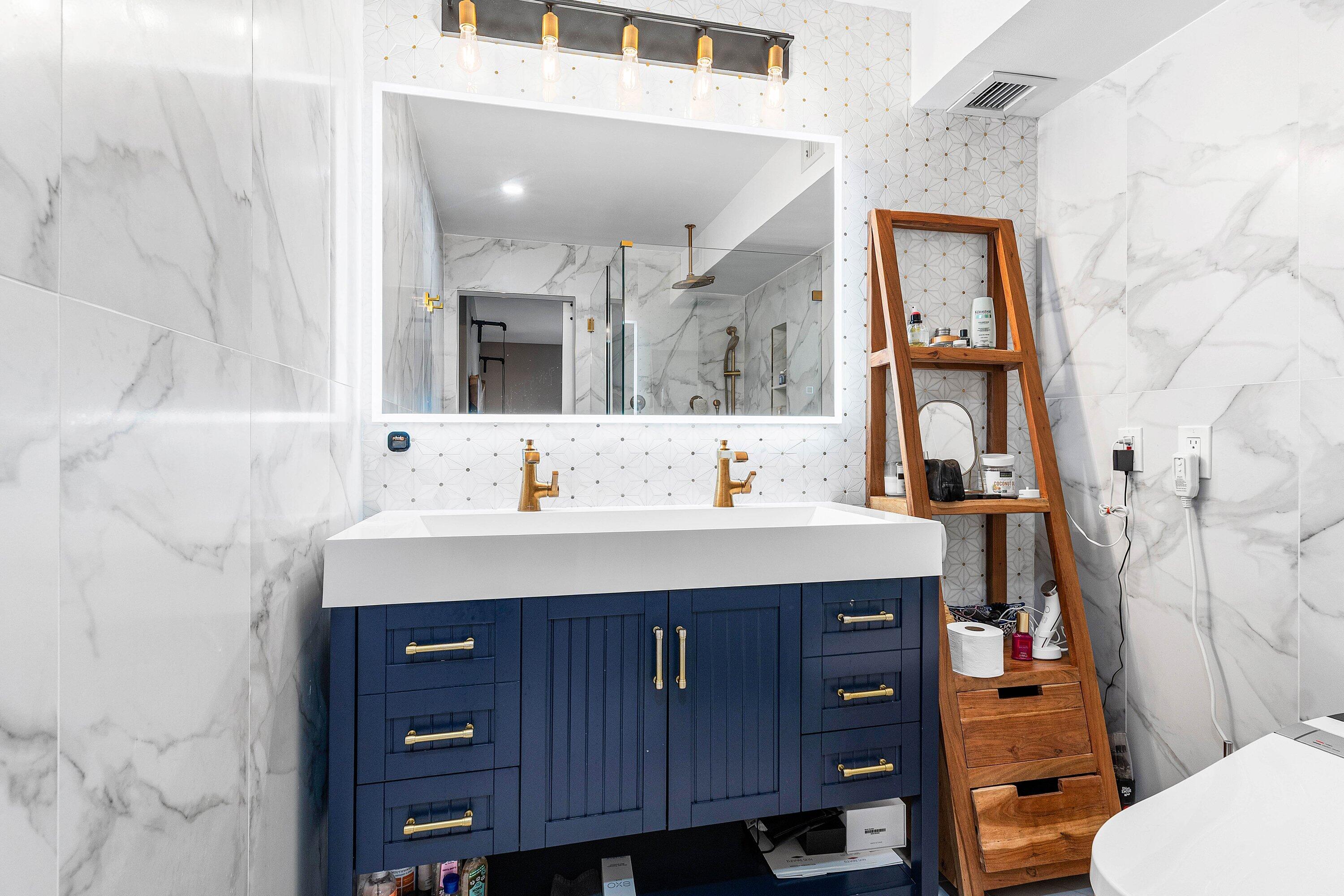 1001 East Camino Real, Unit 4040 Boca Raton, FL 33432 - Photo 20 of 44 a bathroom with a sink vanity mirror and toilet
