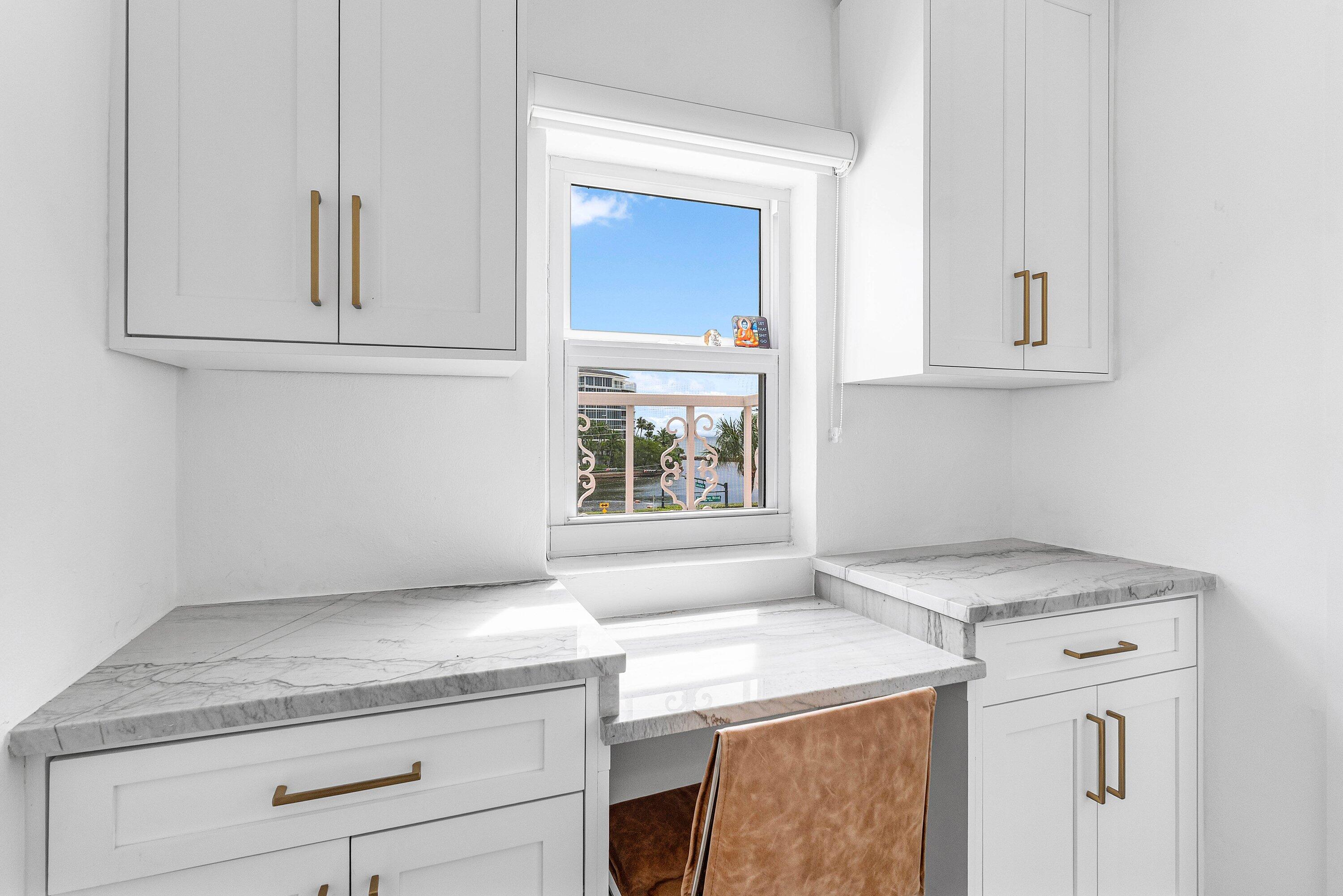 1001 East Camino Real, Unit 4040 Boca Raton, FL 33432 - Photo 24 of 44 a utility room with granite countertop cabinets washer and dryer