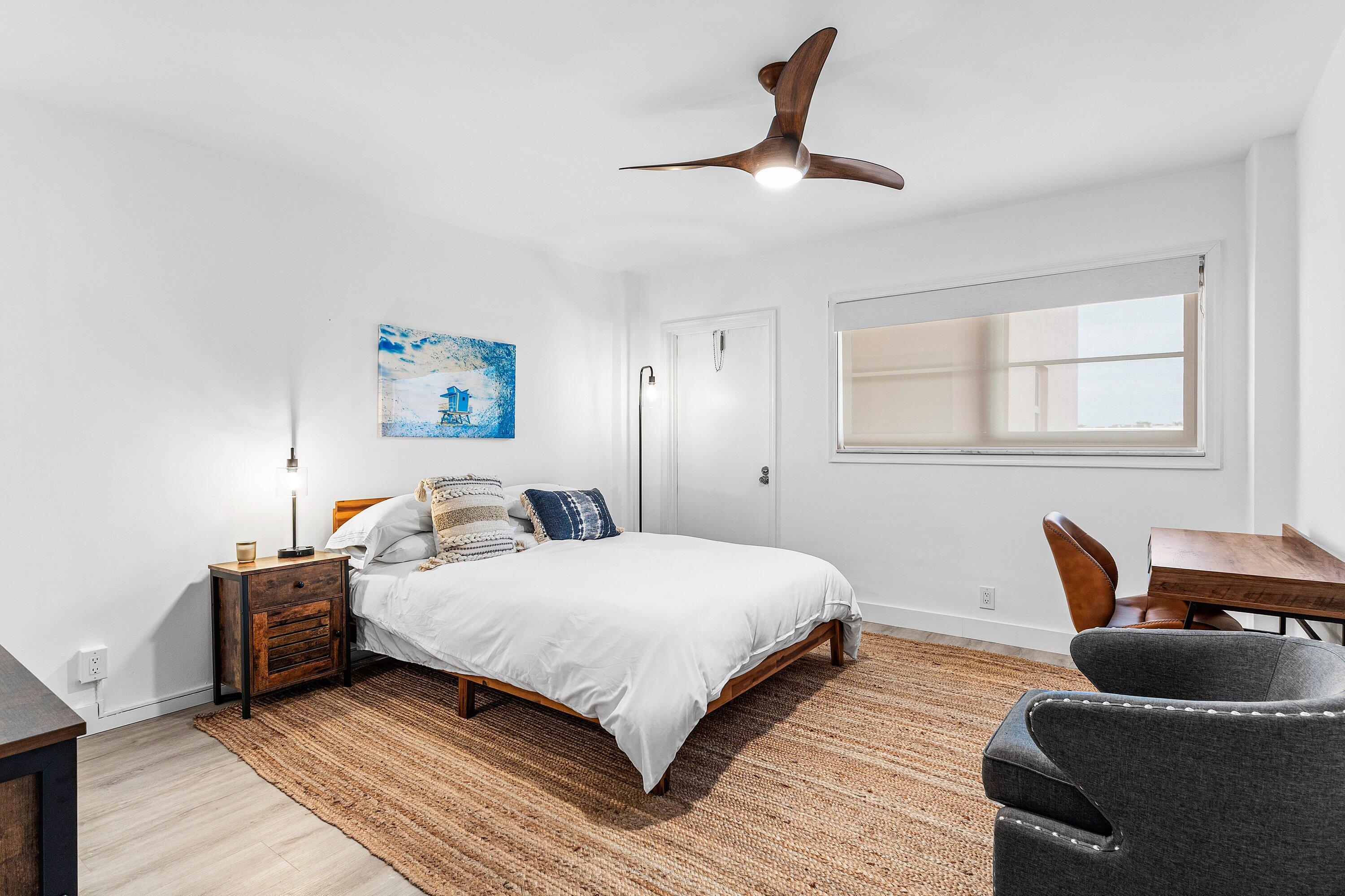 1001 East Camino Real, Unit 4040 Boca Raton, FL 33432 - Photo 27 of 44 a bedroom with a bed and a couch