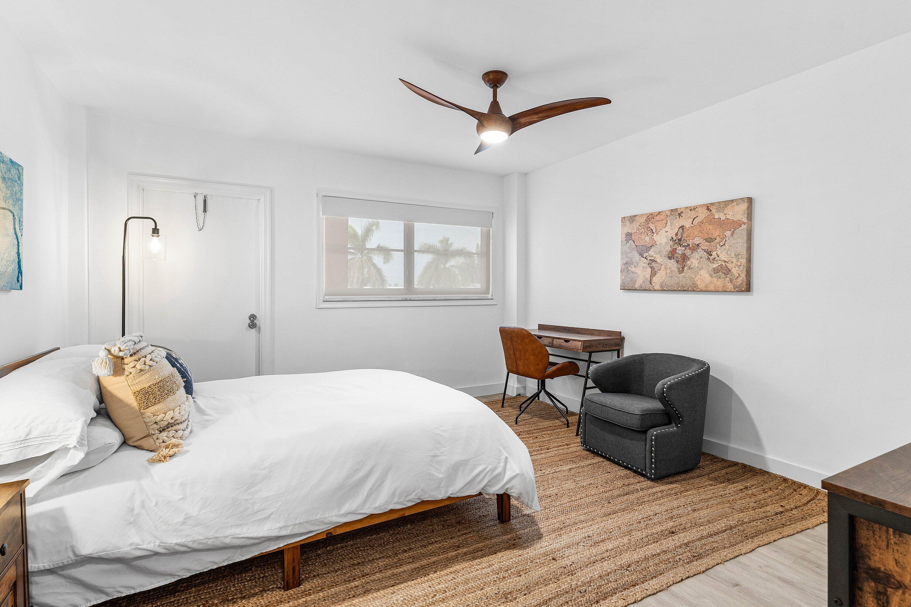 1001 East Camino Real, Unit 4040 Boca Raton, FL 33432 - Photo 28 of 44 a bedroom with furniture and a window