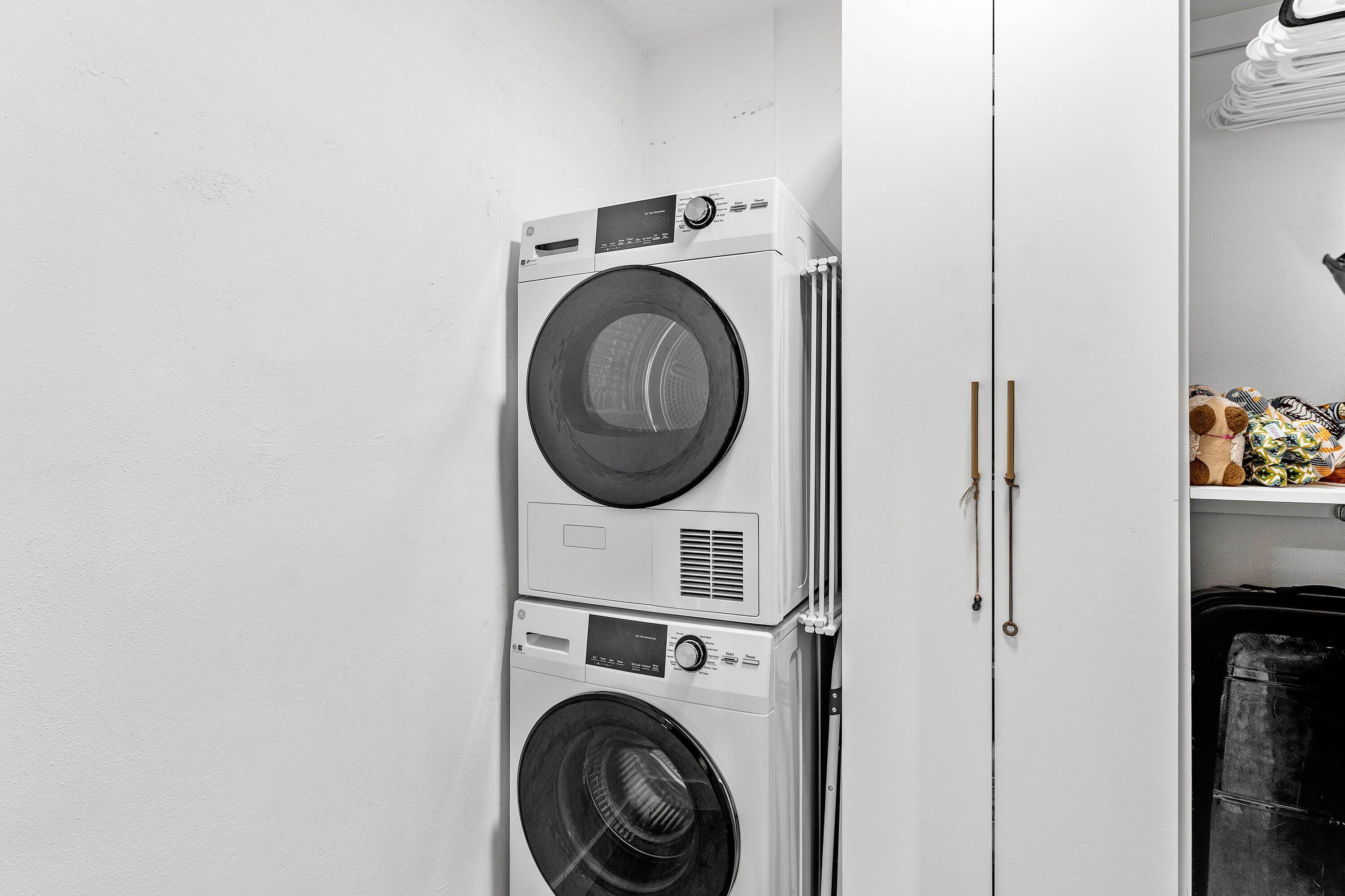 1001 East Camino Real, Unit 4040 Boca Raton, FL 33432 - Photo 29 of 44 a utility room with dryer washer and a view of bedroom