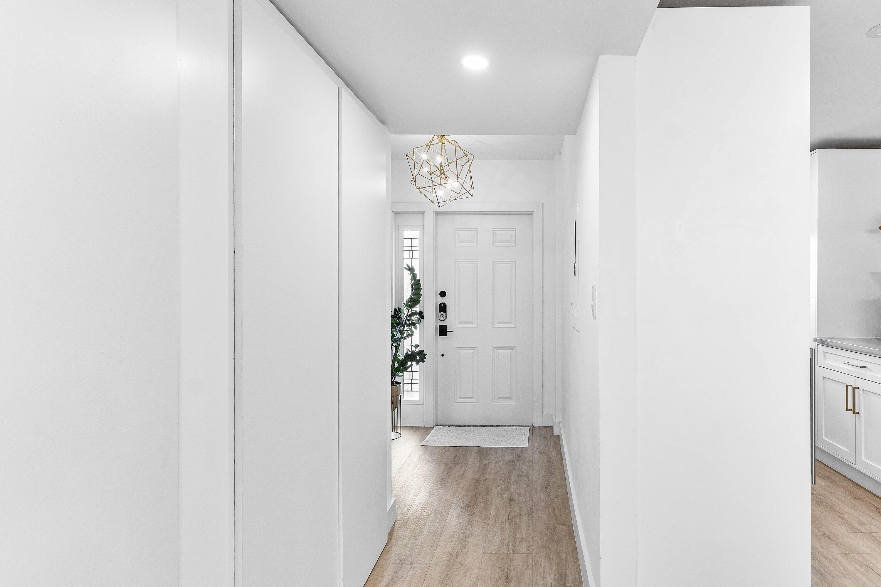 1001 East Camino Real, Unit 4040 Boca Raton, FL 33432 - Photo 3 of 44 a view of a hallway with wooden floor