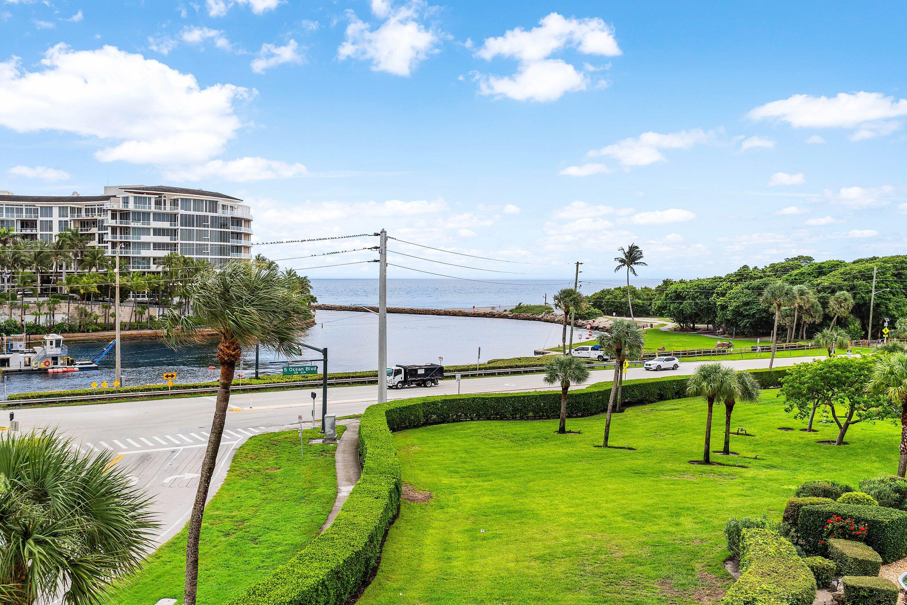1001 East Camino Real, Unit 4040 Boca Raton, FL 33432 - Photo 33 of 44 a view of a swimming pool with a bench and trees
