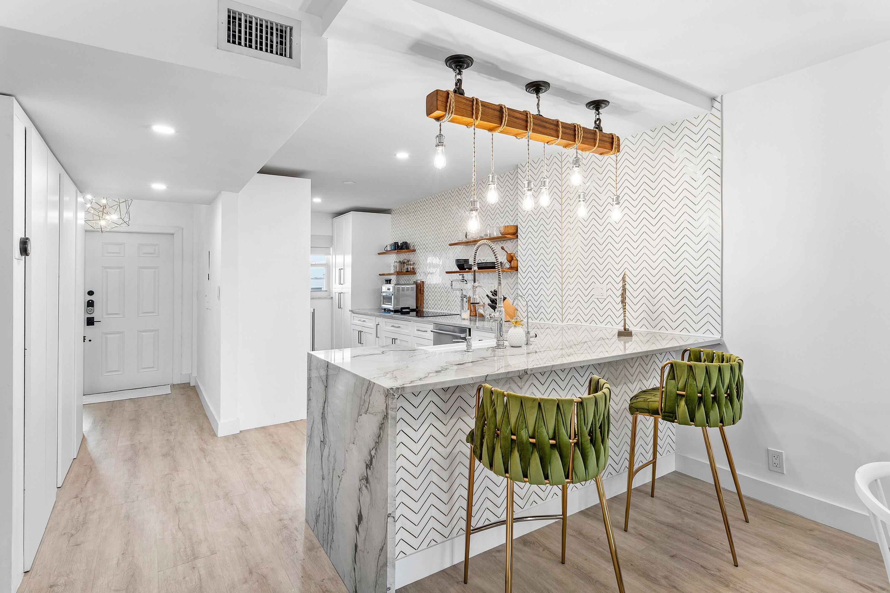 1001 East Camino Real, Unit 4040 Boca Raton, FL 33432 - Photo 4 of 44 a kitchen with a table and chairs in it