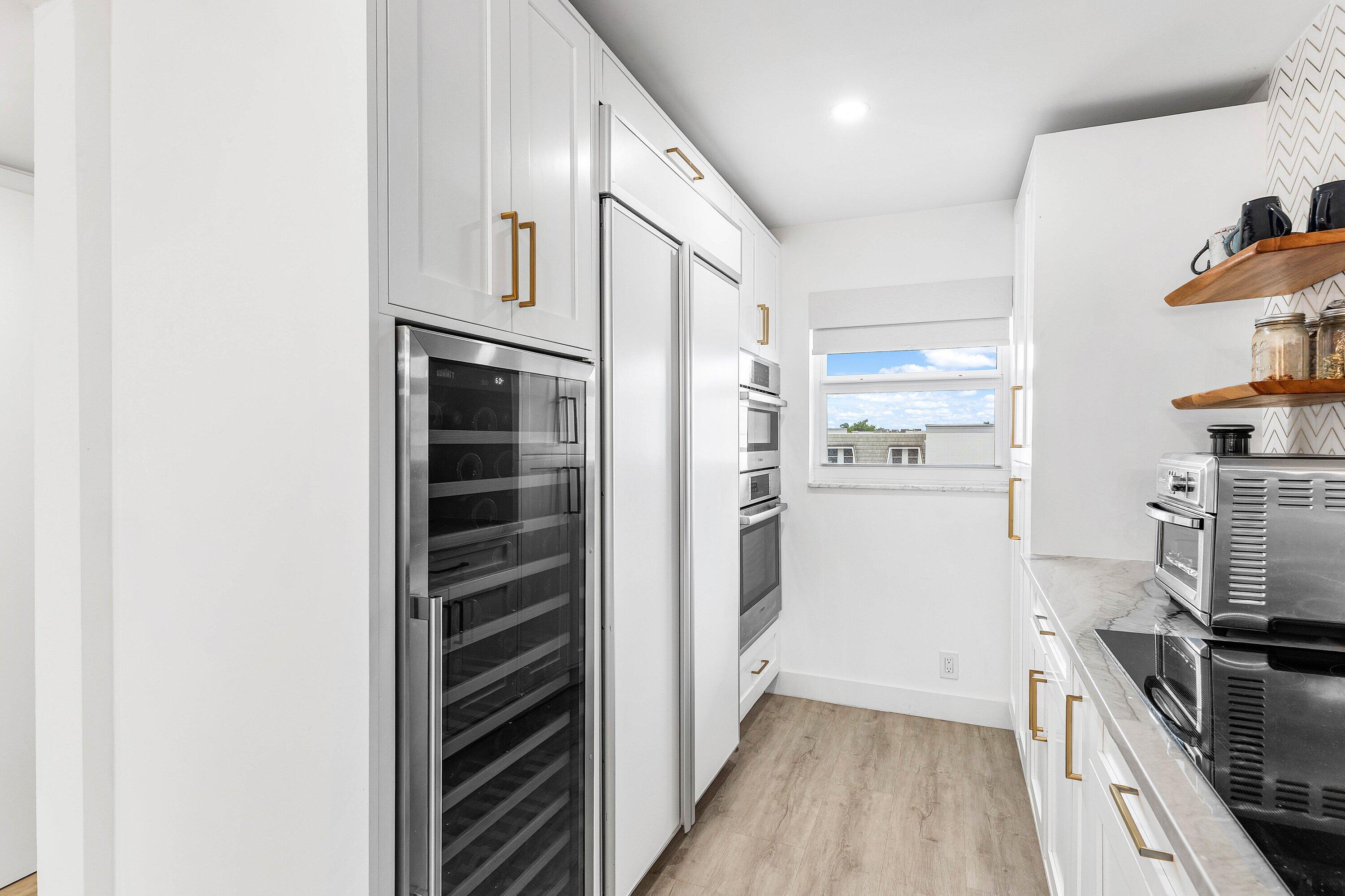 1001 East Camino Real, Unit 4040 Boca Raton, FL 33432 - Photo 9 of 44 a kitchen with cabinets and stainless steel appliances
