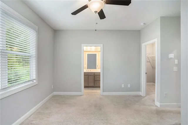 a view of a livingroom with a ceiling fan and window