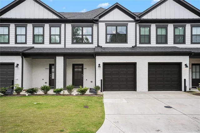 front view of a brick house with a yard
