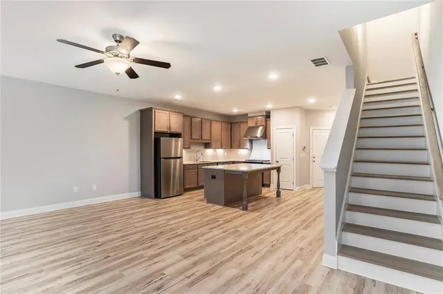 a view of kitchen with sink and refrigerator