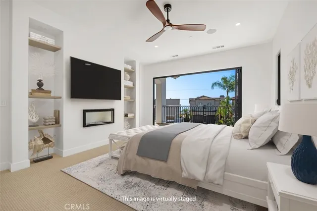 a bedroom with a large bed and a flat screen tv