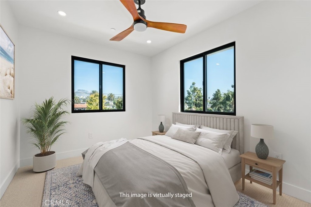 34882 Doheny Place Dana Point, CA 92624 - Photo 28 of 42 a bedroom with a large bed and a potted plant