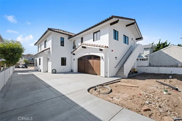 a view of a white house with a yard