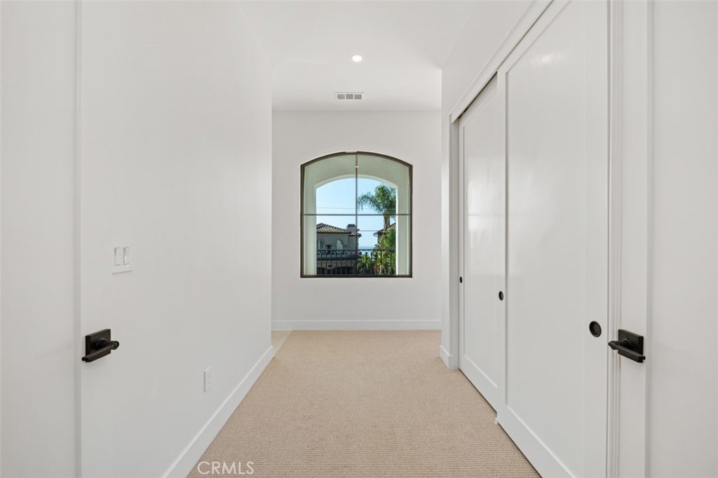 34882 Doheny Place Dana Point, CA 92624 - Photo 10 of 42 a view of a hallway with wooden floor