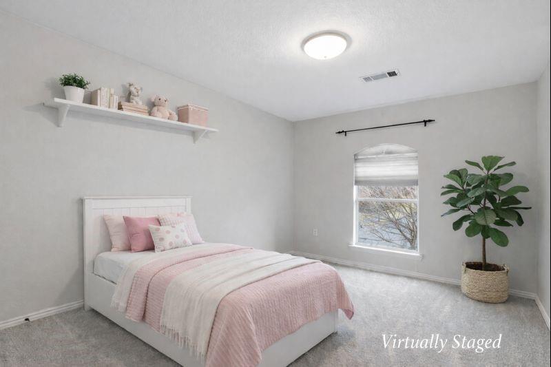 913 Cross Plains Drive Allen, TX 75013 - Photo 28 of 40 a bedroom with a bed and a potted plant