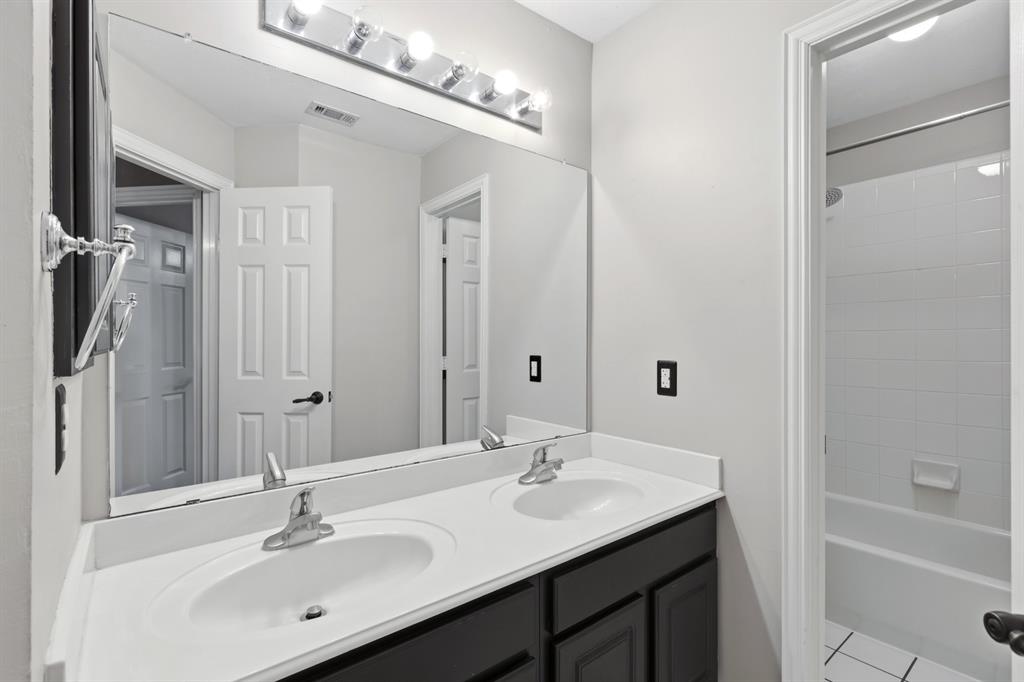 913 Cross Plains Drive Allen, TX 75013 - Photo 33 of 40 a bathroom with a sink double vanity granite tub shower and a mirror
