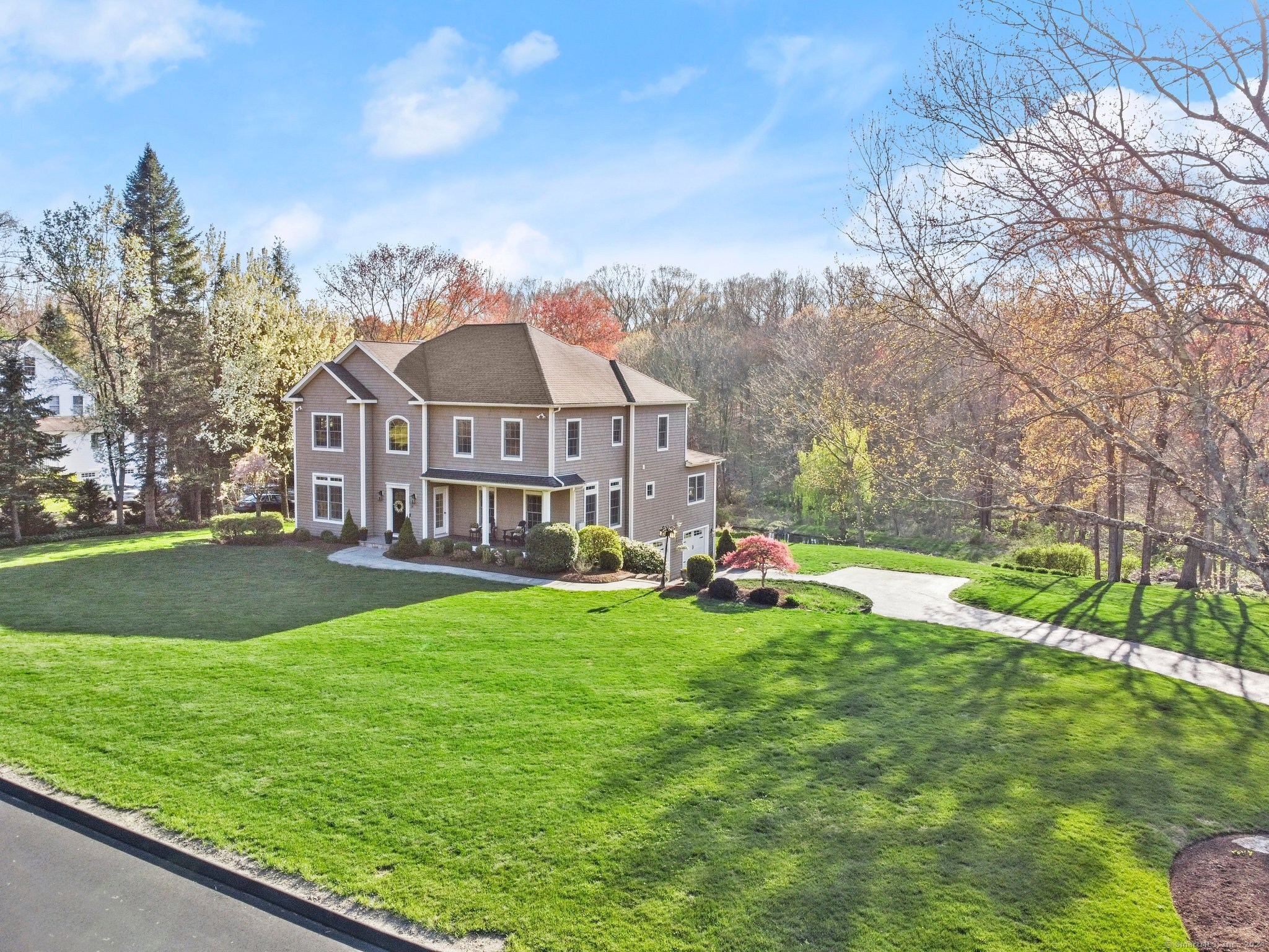 a view of a house with backyard and sitting area