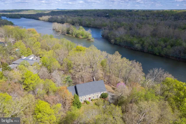 an aerial view of a house with a yard and lake view