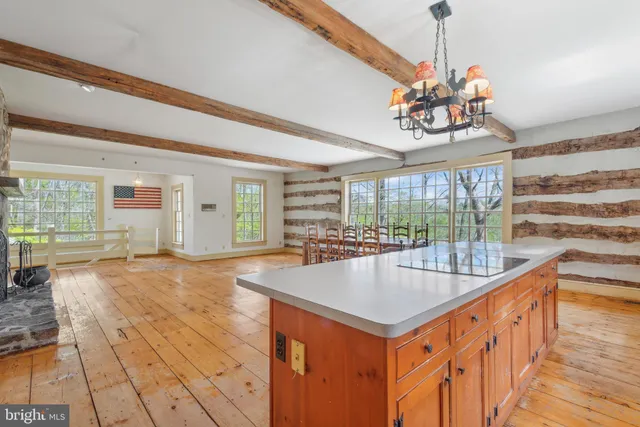 a view of a livingroom with wooden floor and a fireplace
