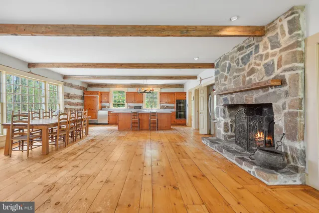 a view of empty room with wooden floor and fireplace