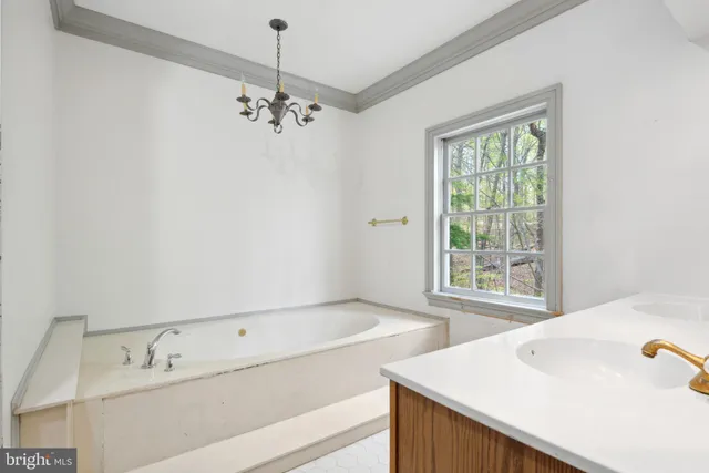 a view of a room with a large window and wooden floor