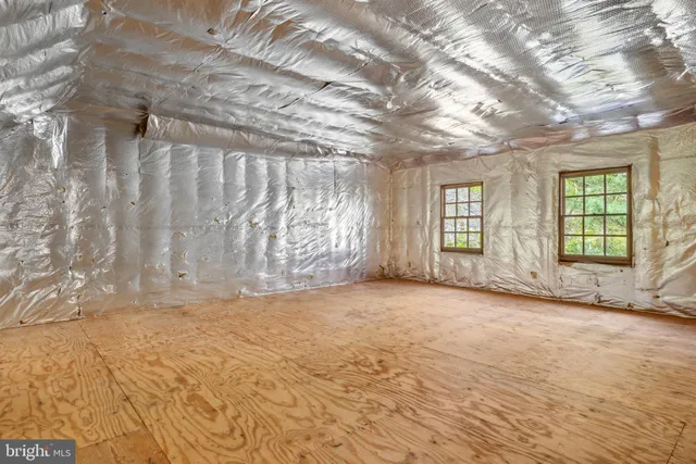 a view of a livingroom with wooden floor and a ceiling fan