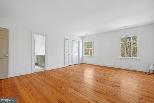a view of a house with a yard and potted plants