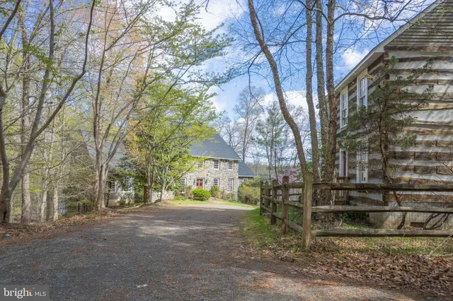 a large room with wooden floor fire place and furniture