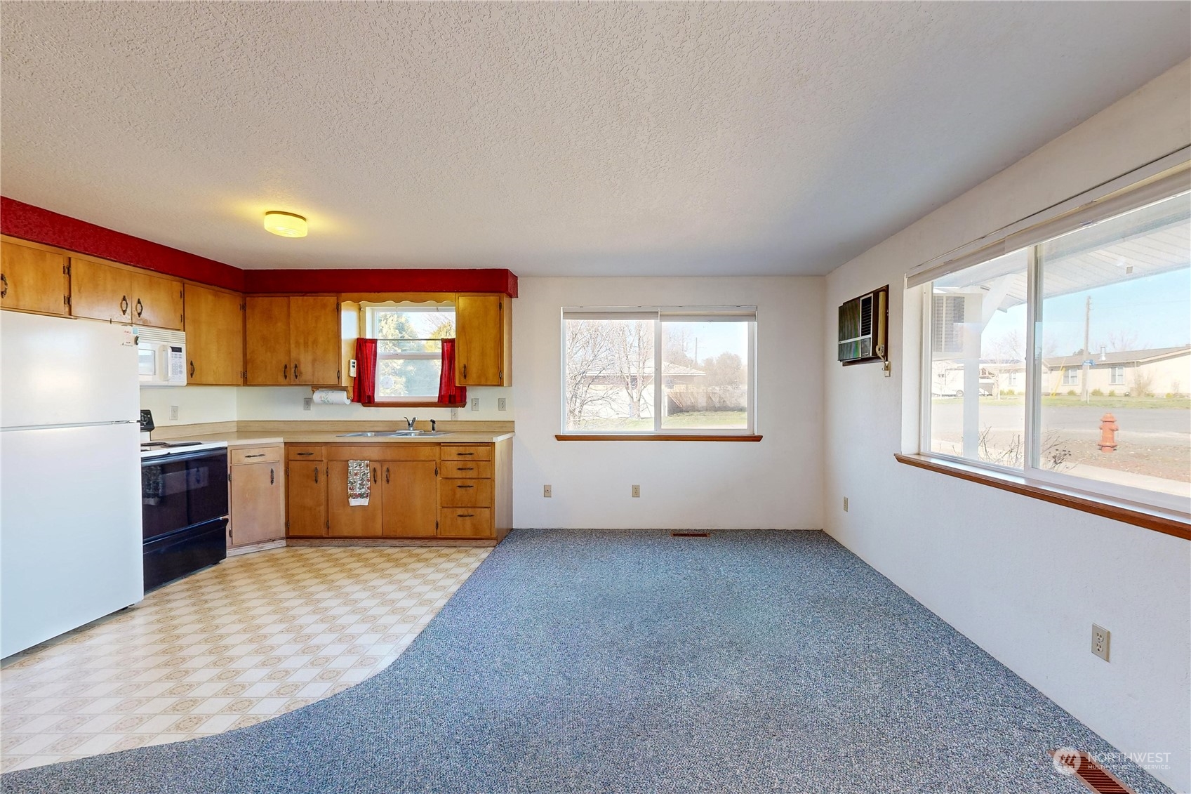 446 North 3rd Street Athena, OR 97813 - Photo 3 of 22 a kitchen with stainless steel appliances a sink a stove a refrigerator cabinets and a window