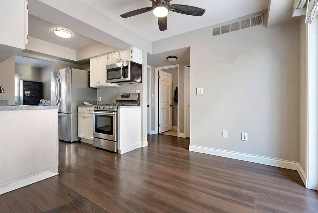2615 Prairieview Lane Aurora, IL 60502 - Photo 11 of 24 a kitchen with stainless steel appliances wooden floor and a refrigerator