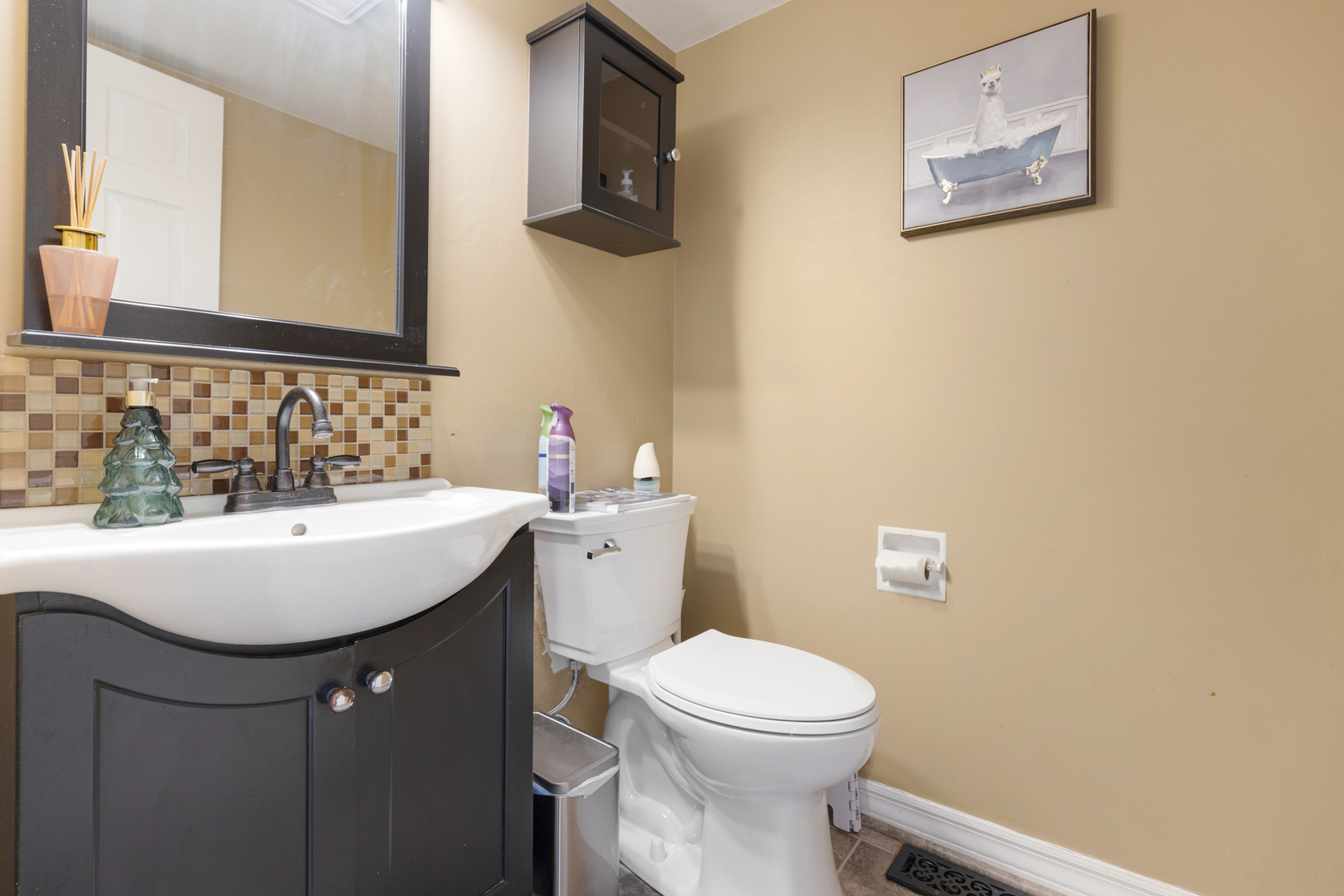 2615 Prairieview Lane Aurora, IL 60502 - Photo 14 of 24 a bathroom with a toilet a sink and mirror