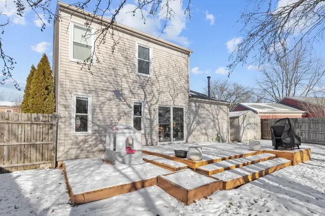 a backyard of a house with barbeque oven