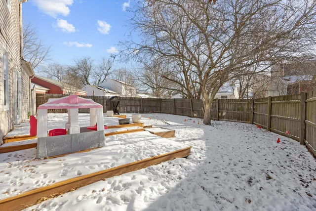 a view of a backyard with a large tree