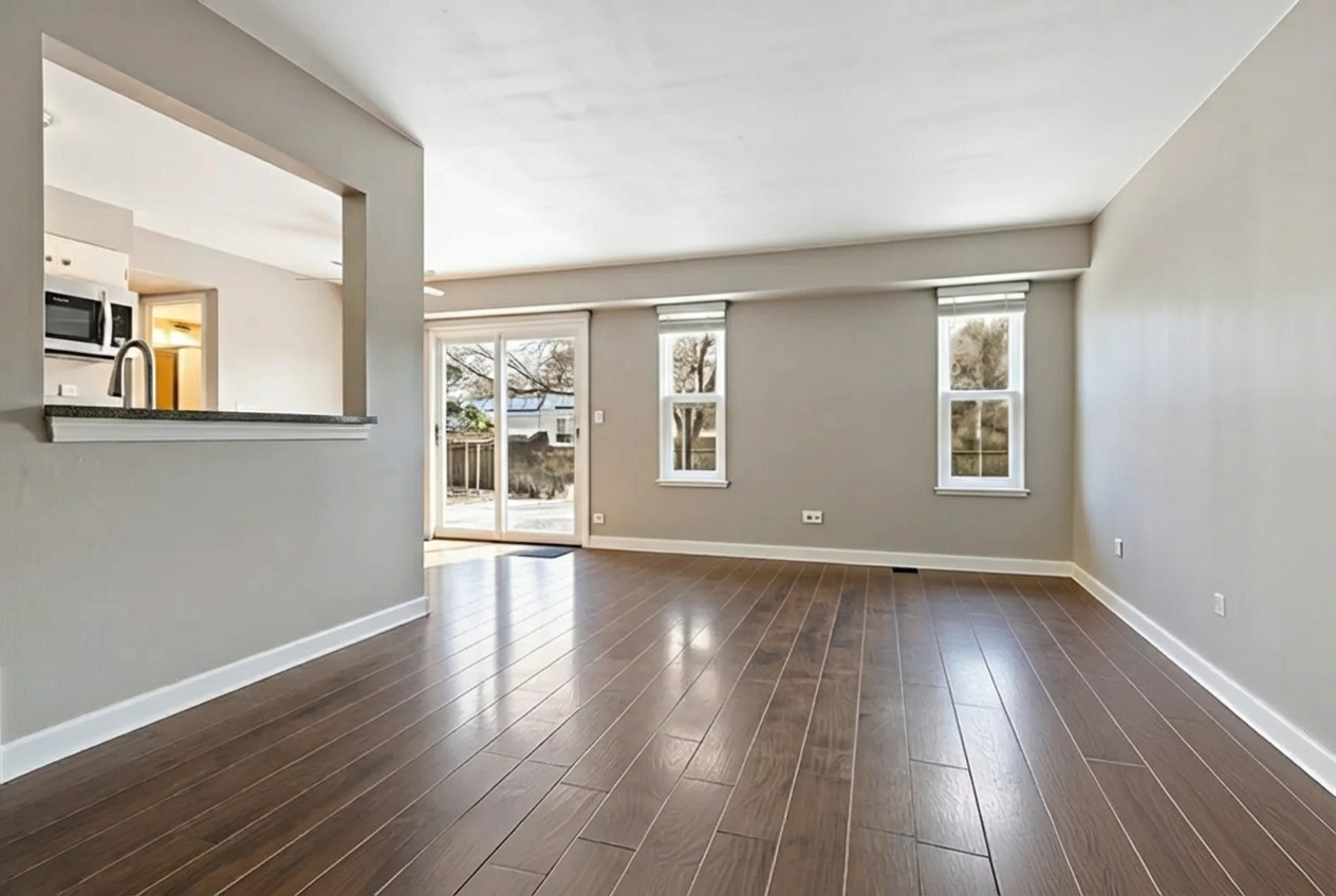 2615 Prairieview Lane Aurora, IL 60502 - Photo 8 of 24 a view of an empty room with wooden floor and a window