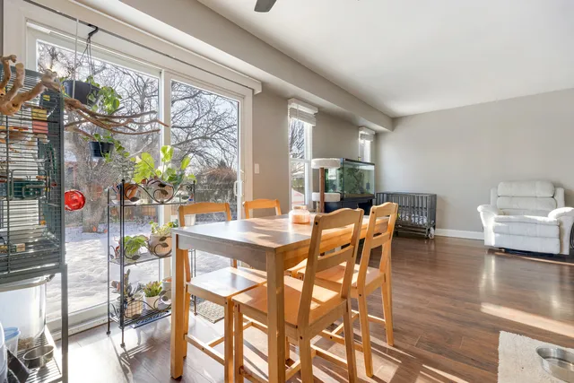 a dining room with furniture a chandelier and wooden floor