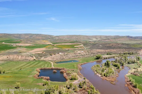 a view of a field with an ocean view