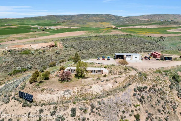 a white house that has a tree in front of it