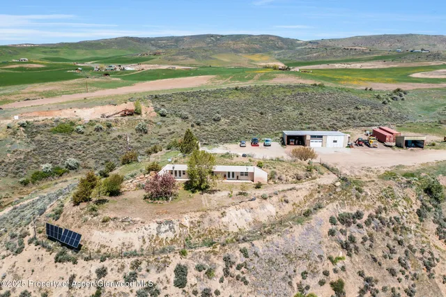 a white house that has a tree in front of it