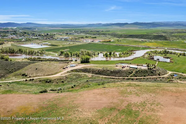 a view of empty room with wooden floor and window