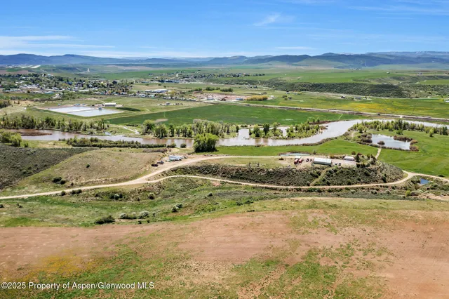 a view of empty room with wooden floor and window