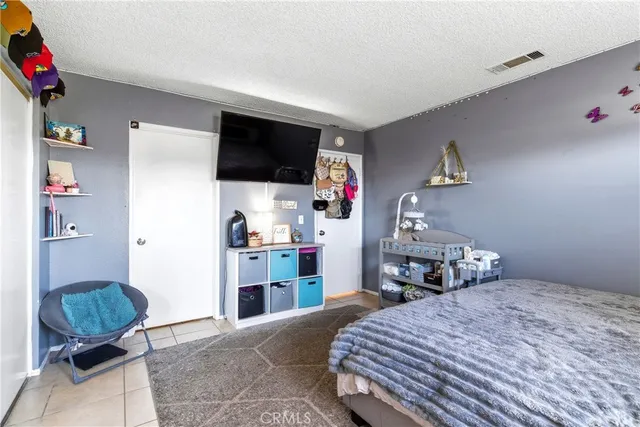 a bedroom with a bed and a television