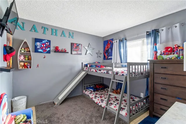 a bedroom with furniture and a wooden floor