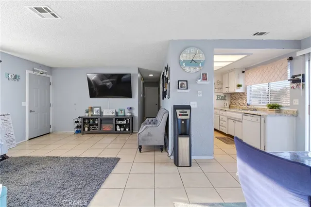 a view of a living room kitchen and a flat screen tv