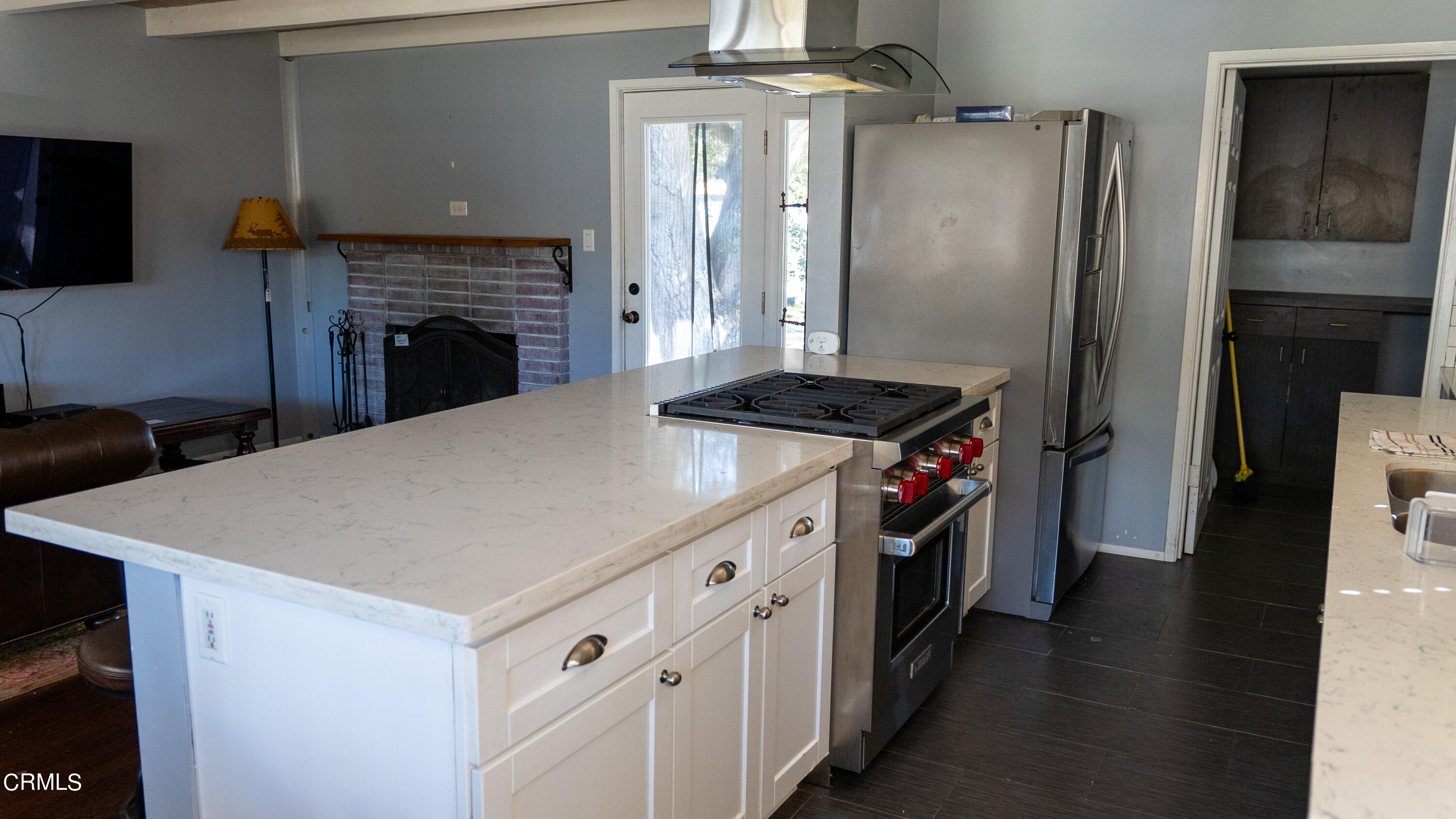 70 Rockaway Road Oak View, CA 93022 - Photo 4 of 20 a kitchen with stainless steel appliances a stove refrigerator and a fireplace