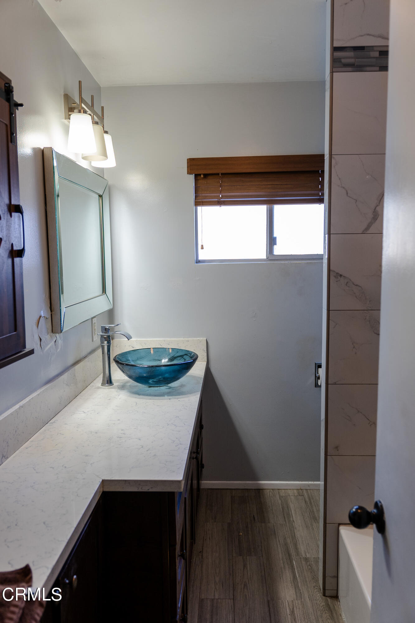 70 Rockaway Road Oak View, CA 93022 - Photo 5 of 20 a bathroom with a sink a mirror and a window