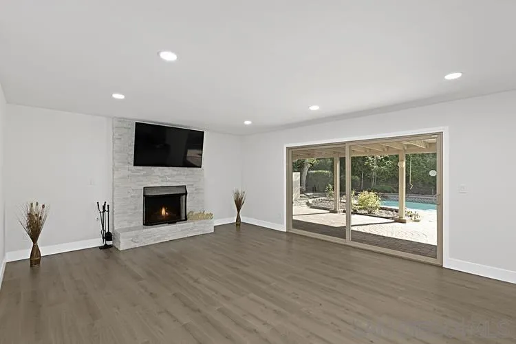4334 Corral Canyon Road Bonita, CA 91902 - Photo 13 of 32 a view of an empty room with a fireplace and a large window