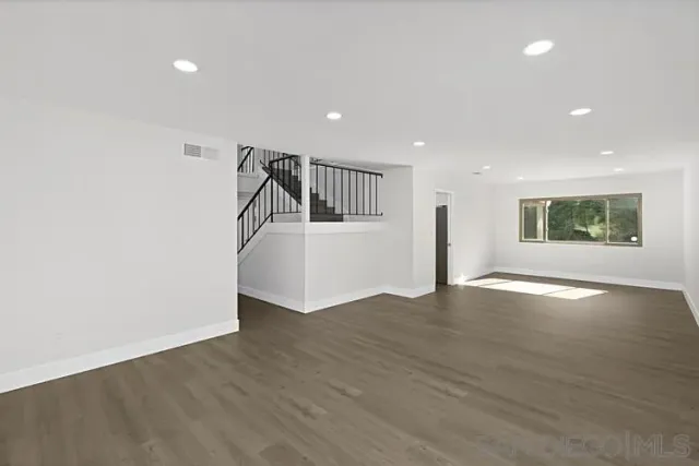 a view of an empty room and a window