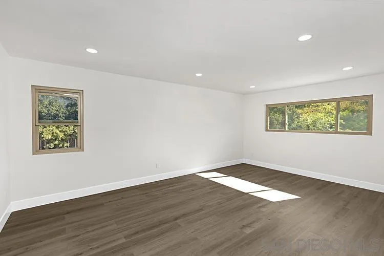 4334 Corral Canyon Road Bonita, CA 91902 - Photo 23 of 32 a view of an empty room with wooden floor and a window