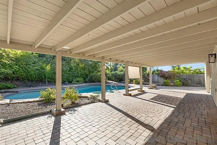 4334 Corral Canyon Road Bonita, CA 91902 - Photo 24 of 32 a view of a patio with table and chairs potted plants with wooden floor and fence