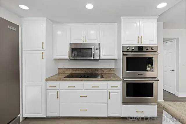 an empty room with wooden floor and a window